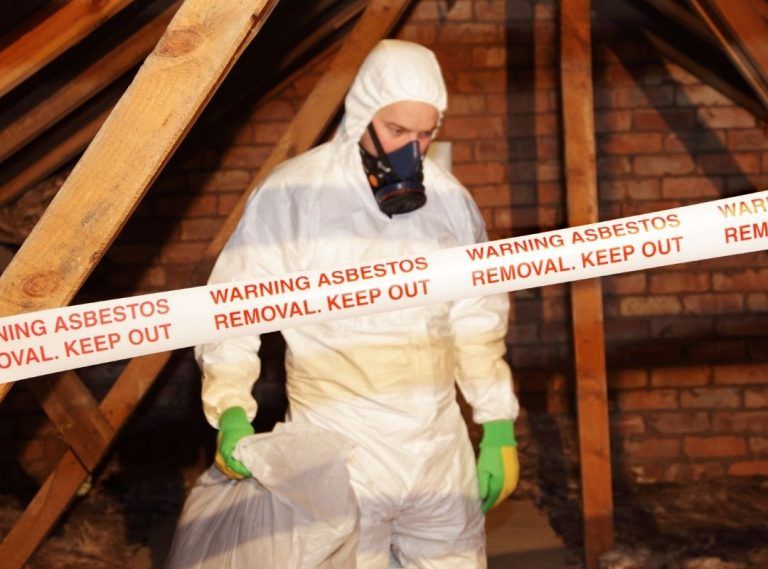 Guy removing asbestos | Featured image for the blog Asbestos in Commercial Buildings from Asbestos removals Brisbane.