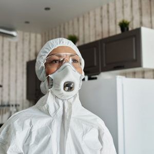 Woman in hazmat suit inspecting home. | Featured image for the blog What to Know About Asbestos, from Asbestos Removals Brisbane.